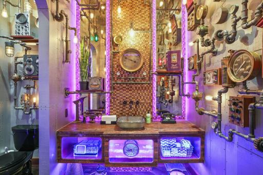 Step into a steampunk-inspired bathroom, where pipes crisscross like half-finished blueprints and gears seem to turn with a mind of their own.