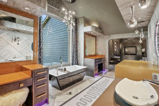 The ensuite bathroom is a grotto of grooming, complete with dramatic views above the soaking tub, and a bordering two-way shower and exercise/meditation roomâan indoor-outdoor sanctuary that blends spa, gym, and starlit escape.