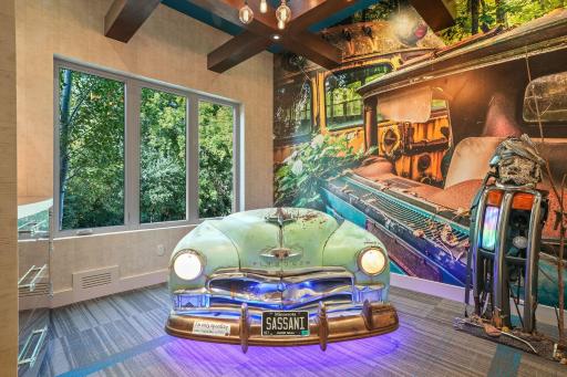 A vintage car desk, horn included, sits ready for inspiration, flanked by glowing cabinetry that makes even spreadsheets feel like spellwork.