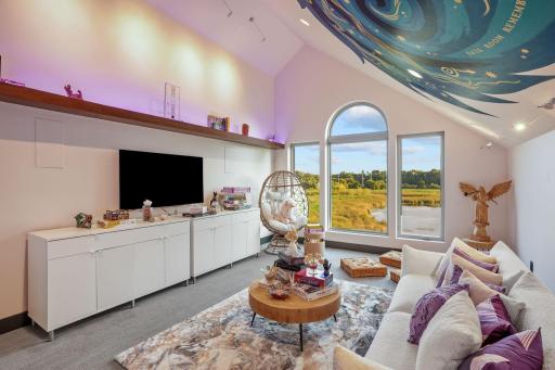A celestial ceiling mural transports visitors to a cosmic playground. The thoughtfully designed architecture creates an intimate nook perfect for contemplation or play, making this more than just an atticâit's a dimensional gateway getaway.