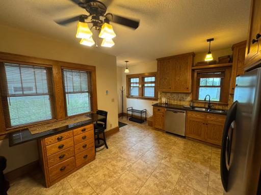 Kitchen with stainless steel appliances and breakfast bar
