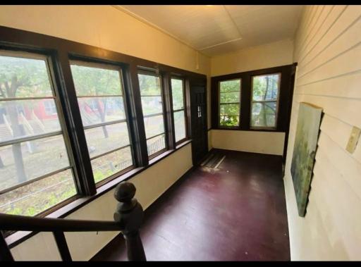 Enter from the exterior into the shared Enclosed Porch, into the main floor unit.