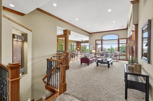 Main floor wrought iron stairway with built in wall fountain.