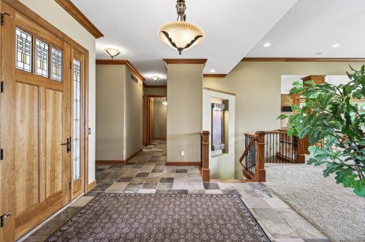 This front door was just refinished to show off its natural beauty. Main floor hallway to powder room, garage, kitchen and elevator.