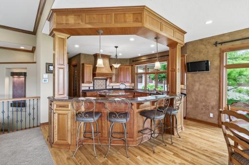View towards the kitchen area and plentiful seating at the kitchen breakfast bar area.