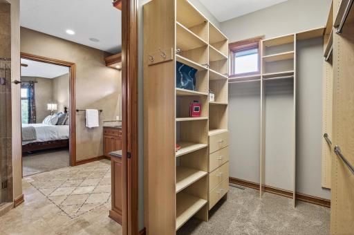 Primary walk in closet with built in organization
