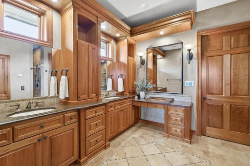 Primary ensuite bathroom with sound and lighting system, double sinks gorgeous granite and natural wood cabinetry and heated floors.