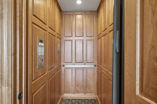 Step into this elegant wood paneled elevator.