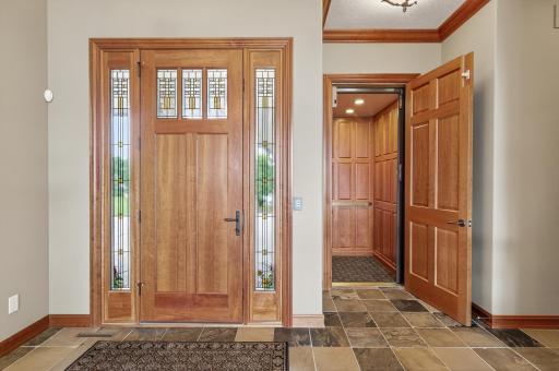 View of this gorgeous front door entry way and elevator entrance.