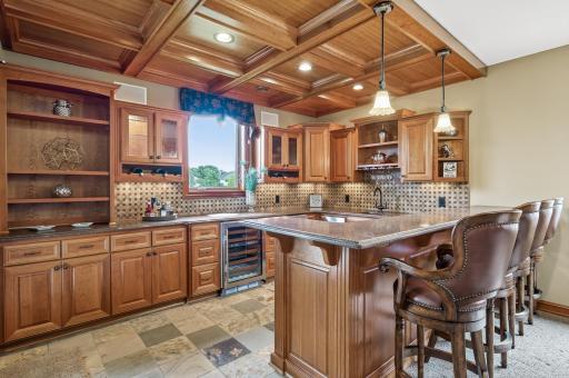 This bar is a must see with Subzero refrigerator and wine fridge, ice maker and microwave, built in sound and light system. Walk right in from the outdoor patio and relax at your own bar with a view of the fairway and green on hole 18 at the Wilds.
