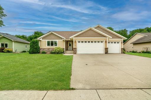 Attractive rambler with manicured lawn and durable concrete driveway