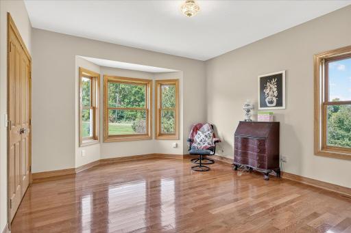 Here is bedroom #3 of 3 on the main level, which features large windows, fresh & neutral paint, solid oak hardwood flooring and is currently being used as a home office.