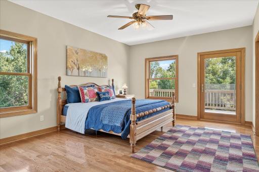 The primary bedroom is huge! It includes a ceiling fan, a walkout to the deck, and so much natural light comes through the windows & patio door.