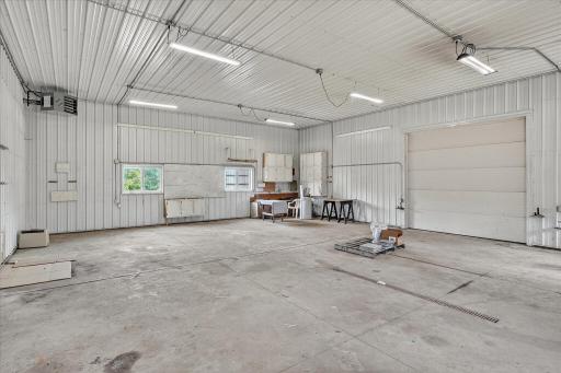 This is the 40 x 32 section of the outbuilding. Its heated too, and features a floor drain, huge doors, tons of lighting and lots of storage too. It also has a separate 100A panel with 20A, 30A and 50A breakers, and a 250v outlet.