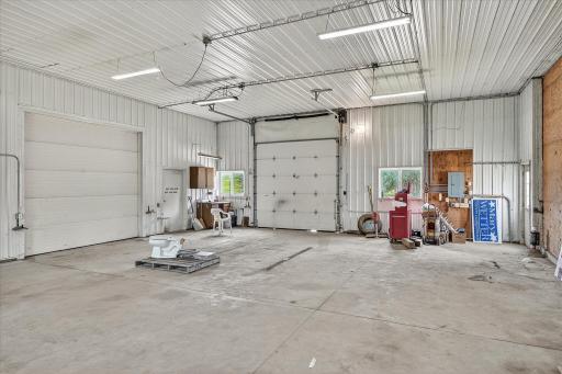 The 10 x 10 doors lead to the pole barn and the driveway, respectively. One has a Chamberlain jackshaft opener. The wood on the right is actually a 13h x 15w sliding door.