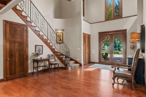 20' high entrance wow's you from the moment you step inside! Gleaming hardwood, impressive staircase, open main floor walls of windows to lake views, niches and display ledge.