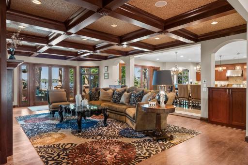 main floor living. gas fireplace, coffered ceiling's, wall of windows, French doors to covered patio, open to kitchen and dining.