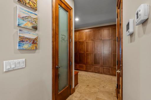 mud room offers closet, bench seating with storage and a wall of storage lockers, all with access to the garage and main floor laundry room.