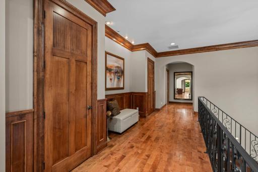 Upper hall with sitting nook flanked by 2 storage closets.