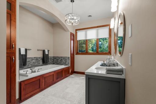 Main floor Primary full bath, newly tiled, new vanity and lighting. 2 storage closets, walk in shower and separate toilet room.