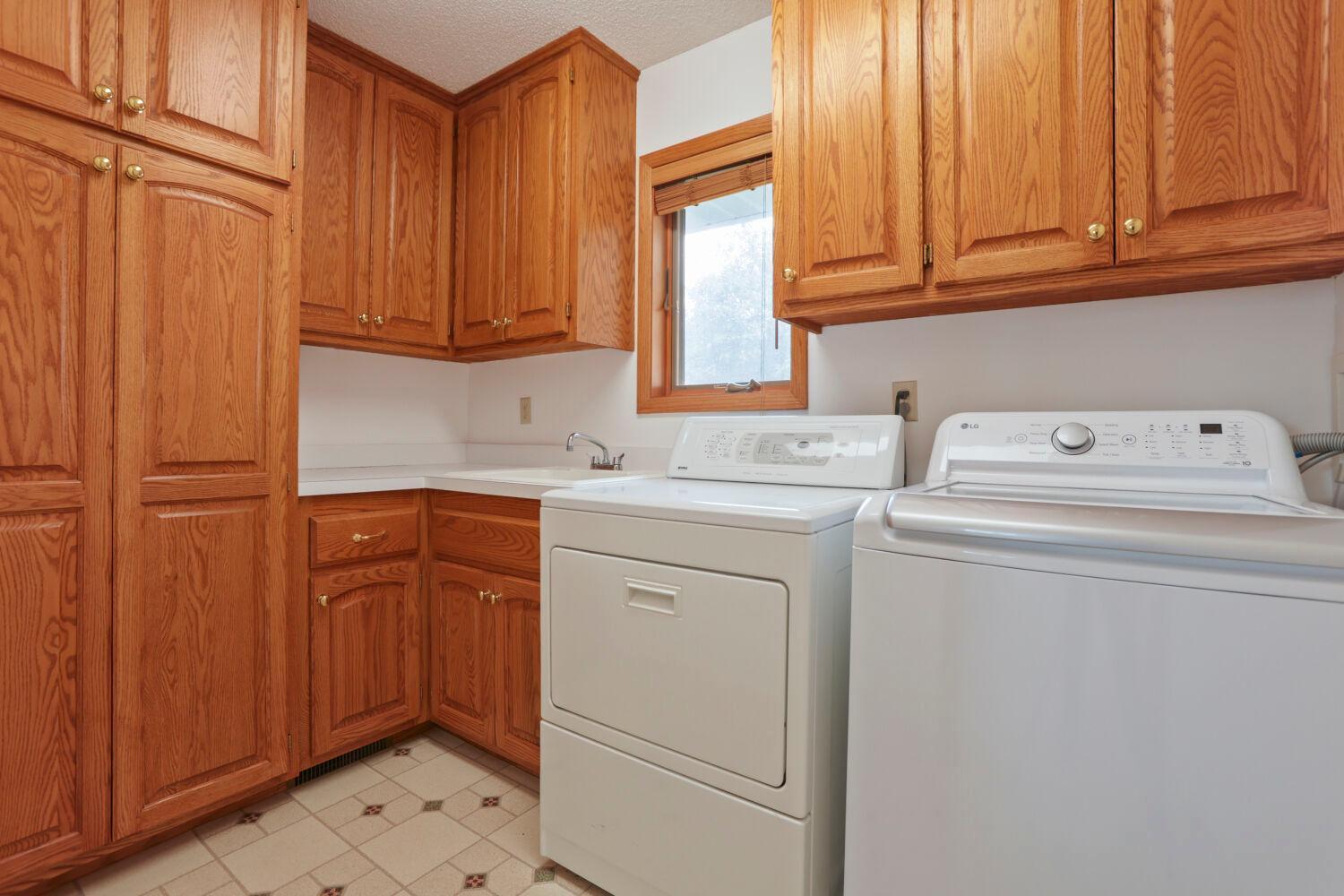 Main level laundry! Look at all the cabinet space!