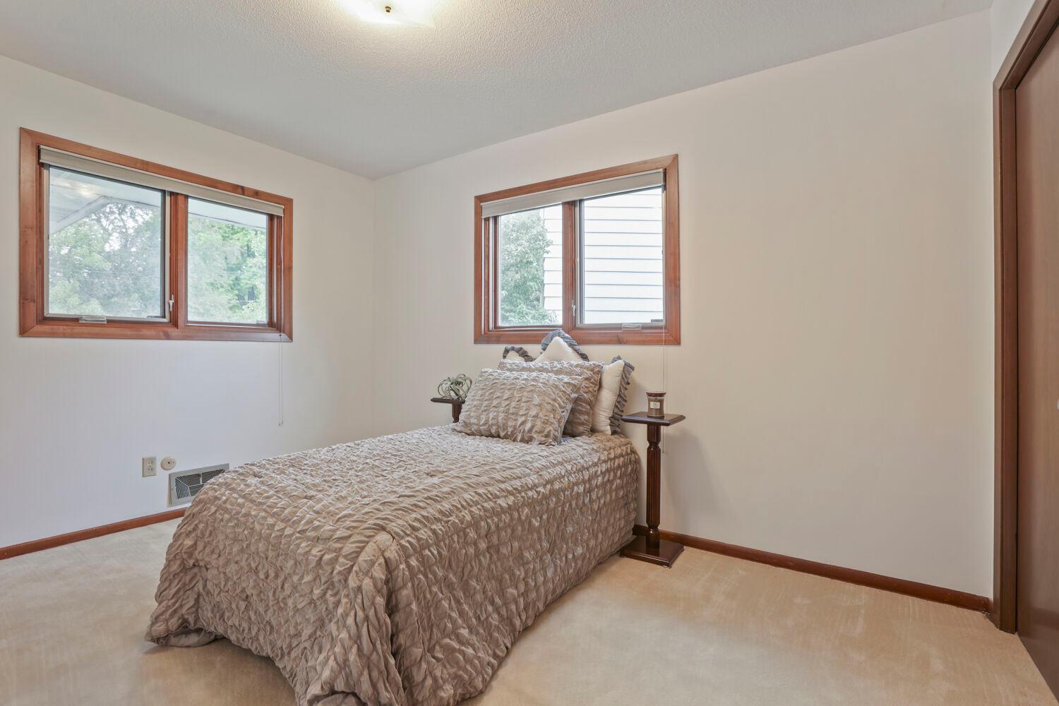 The second bedroom on the main level features two windows.
