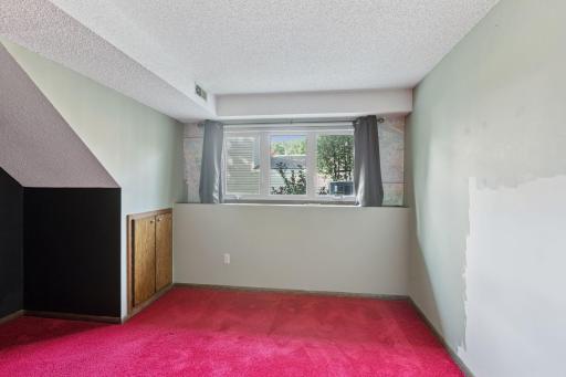 Lower level bedroom with look out windows - one wall needs to be painted