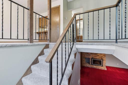 Stairs going to living room - dining room - kitchen - lower level fireplace to the right