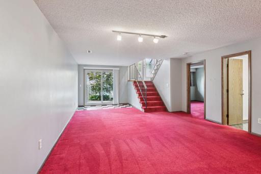Lower level family room - lower level bedroom and bath on the right - walk out to patio