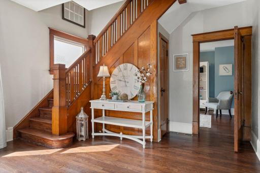 The foyer is grand and filled with rich wood