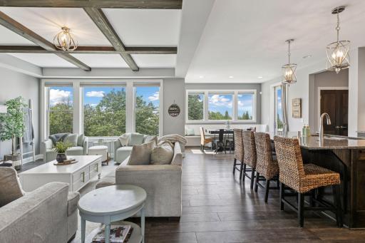 Welcome to a refined custom two-story, crafted by TJB Homes and thoughtfully enhanced throughout all levels. From the moment you enter, expansive windows draw the eye through the home, flooding the interiors with natural light.