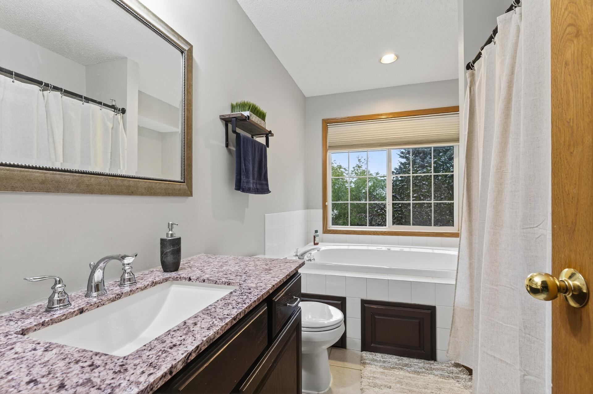 Primary bath featuring stand alone shower & jetted tub!