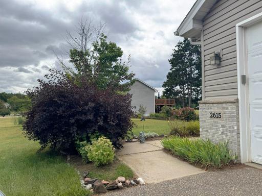 A shot of the walkway leading to the front entrance featuring the landscaping.