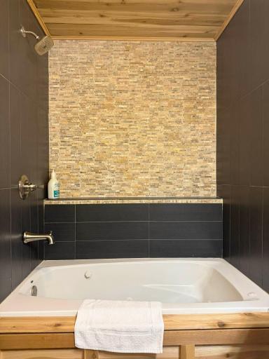 A closer look at the jet tub and shower in the lower level bathroom.