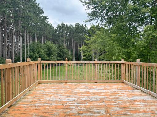 A shot of the deck looking over the private backyard from the dining room patio door.