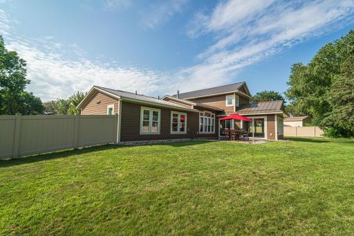 The fully-fenced backyard has two gates - a double and a single. A stamped concrete patio lies off the four season porch.