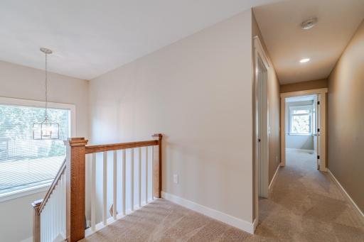 The upper level has its own separate zone for AC and heat. This space has custom white doors and trim. Two bedrooms and a FULL bath lie on this level.