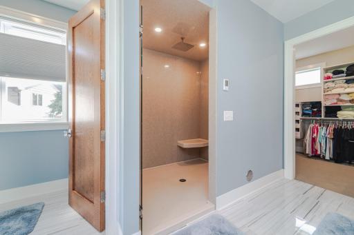 The 5â x 6â6â walk-in shower with onyx walls, rainhead and handheld showerheads and a shower seat. There is almost instant hot water with a recirculating system for domestic hot water.
