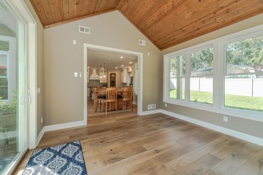 The four-season porch takes in views of the fenced in backyard.