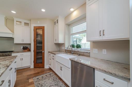 The kitchen has geo-thermal in-floor heat, as well as a walk-in pantry, granite countertops and a farmhouse sink.