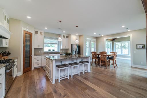 The kitchen is classic-elegance, with white enameled, CUSTOM, recessed flat panel cabinetry with soft-close drawers.