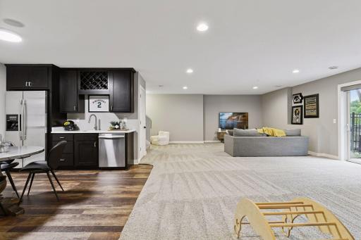 The walk-out lower level features the family room with wet bar and guest bedroom with adjacent bathroom.