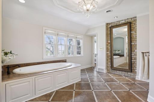 The primary bathroom boasts a soaking tub, dual vanities, a walk in shower, and a private toilet closet.