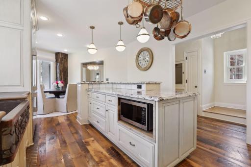 The bright kitchen with granite countertops, tile backsplash, custom cabinetry, and Decor appliances which were new to the home in 2023.