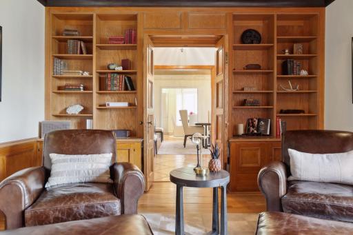 The study features a cozy gas fireplace and a hidden wet bar to enjoy a nightcap.