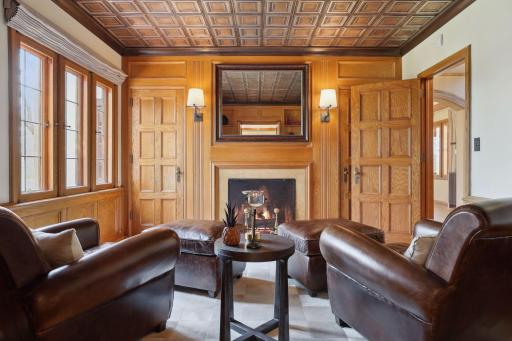 The study features a cozy gas fireplace and a hidden wet bar to enjoy a nightcap.