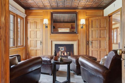 The study features a cozy gas fireplace and a hidden wet bar to enjoy a nightcap.