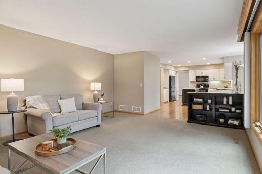 The kitchen and dining area flow seamlessly into the spacious family room, creating a warm and connected living space.