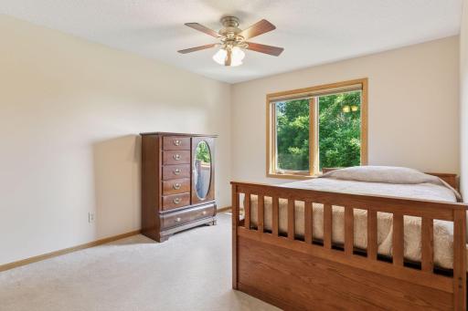 Fourth upstairs bedroom featuring beautiful views of the private backyard.