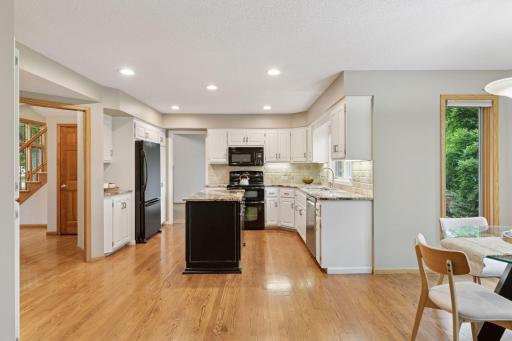 The open and updated kitchen offers ample space, with the potential to be extended for additional island seating, counter space, or cabinetry-perfect for entertaining or everyday functionality!